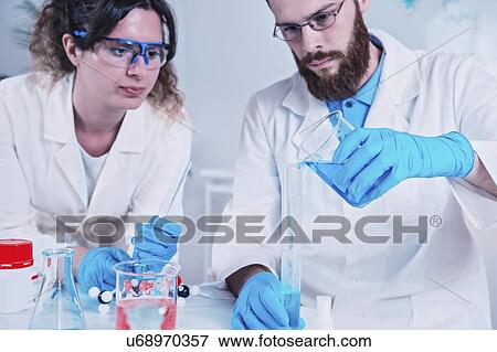 Stock Photo - Young scientists working in laboratory. Fotosearch