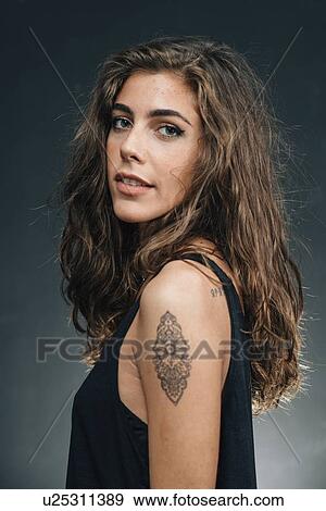 Stock Photo - Young woman with tattoo. Fotosearch