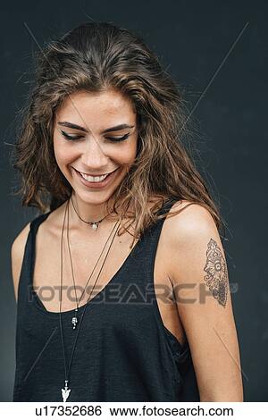 Stock Photograph - Young woman with tattoo. Fotosearch