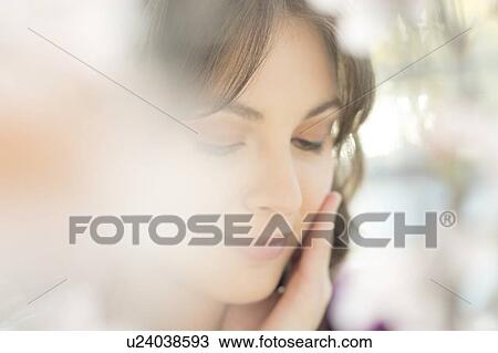 Young women touching her face View Large Photo Image Stock Image - Young women touching her face. Fotosearch