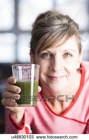 Stock Image - A green smoothie is made of green vegetables and fruit.. Fotosearch