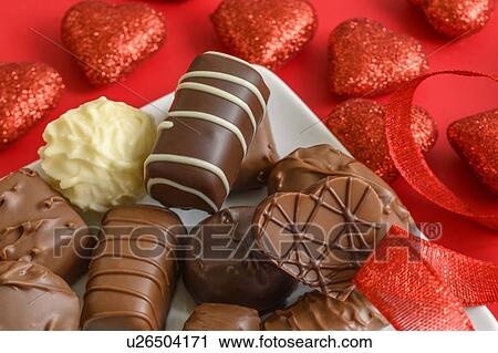 Stock Image - Assorted chocolates with red hearts. Fotosearch