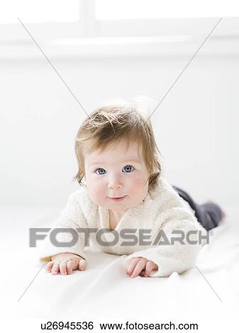 Baby girl lying on her front View Large Photo Image Stock Photograph - Baby girl lying on her front. Fotosearch