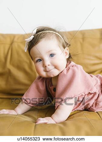 Baby girl lying on sofa View Large Photo Image Stock Image - Baby girl lying on sofa. Fotosearch