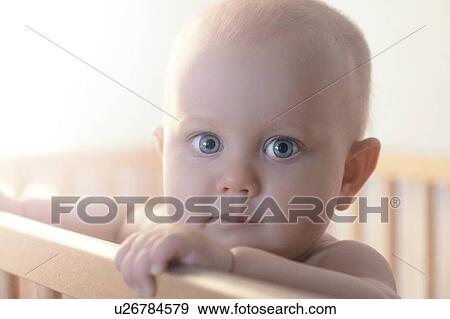 Stock Photo - Baby in crib. Fotosearch