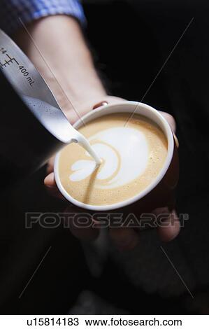 Barista pouring milk into coffee View Large Photo Image Stock Image - Barista pouring milk into coffee. Fotosearch
