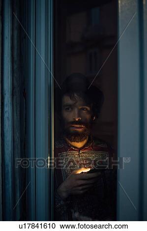 Bearded young man in deep thought by window View Large Photo Image Stock Image - Bearded young man in deep thought by window. Fotosearch