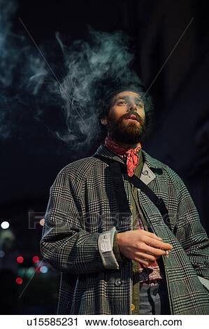 Bearded young man loitering on street View Large Photo Image Stock Image - Bearded young man loitering on street. Fotosearch