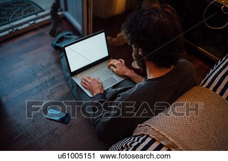 Bearded young man using laptop in bedroom View Large Photo Image Stock Image - Bearded young man using laptop in bedroom. Fotosearch