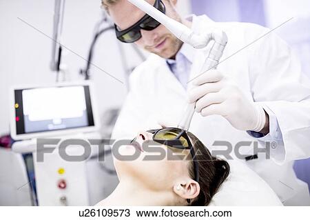 Stock Image - Beauty technician using laser treatment. This treatment is used to treat scars, wrinkles and stretch marks, but also for pigmentation removal.. Fotosearch
