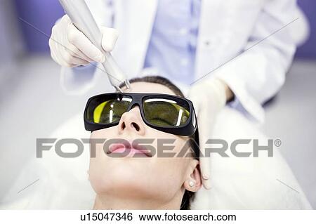 Beauty technician using laser treatment. View Large Photo Image Stock Photograph - Beauty technician using laser treatment.. Fotosearch