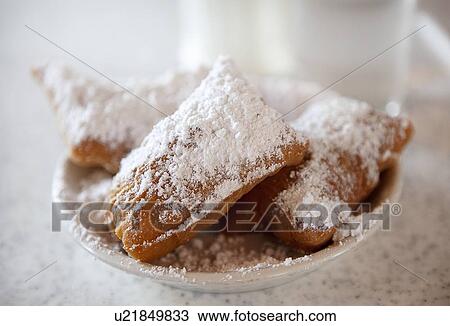 Beignets with powdered sugar on plate View Large Photo Image Stock Image - Beignets with powdered sugar on plate. Fotosearch