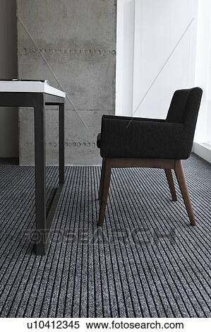 Stock Photography - Black chair by desk. Fotosearch