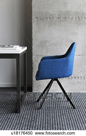 Stock Image - Blue chair by desk. Fotosearch
