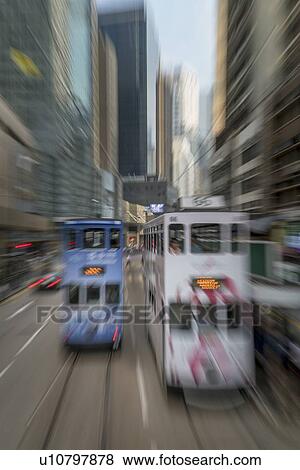 Blurred image of double-decker trams on street in Hong Kong, China View Large Photo Image Stock Photo - Blurred image of double-decker trams on street in Hong Kong, China. Fotosearch