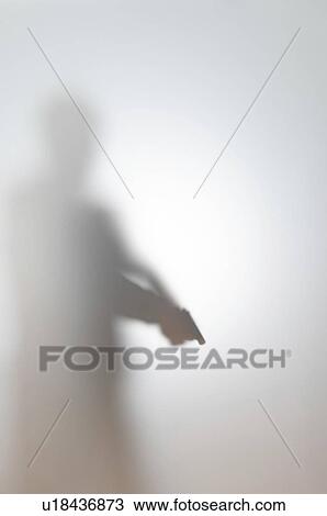 Stock Image - Blurred silhouette of a man with a gun.. Fotosearch