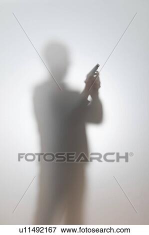 Stock Photo - Blurred silhouette of a man with a gun.. Fotosearch
