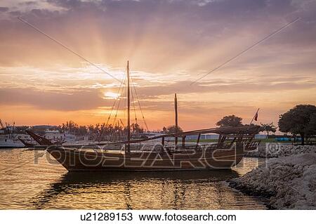 Boat at sunset in Doha, Qatar View Large Photo Image Stock Image - Boat at sunset in Doha, Qatar. Fotosearch