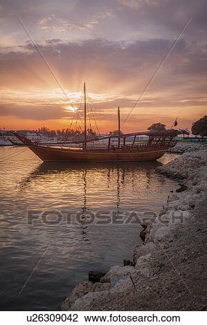 Boat at sunset in Doha, Qatar View Large Photo Image Stock Image - Boat at sunset in Doha, Qatar. Fotosearch