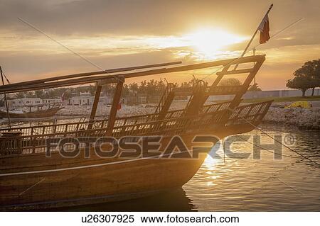 Boat at sunset in Doha, Qatar View Large Photo Image Stock Photography - Boat at sunset in Doha, Qatar. Fotosearch