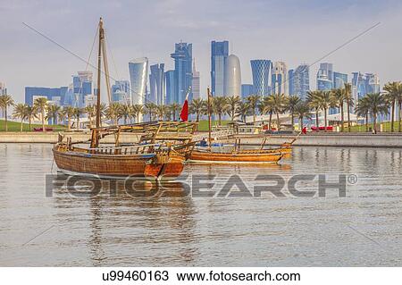 Stock Image - Boats by skyscraper skyline in Doha, Qatar. Fotosearch