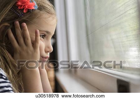 Stock Photo - Bored girl by window. Fotosearch