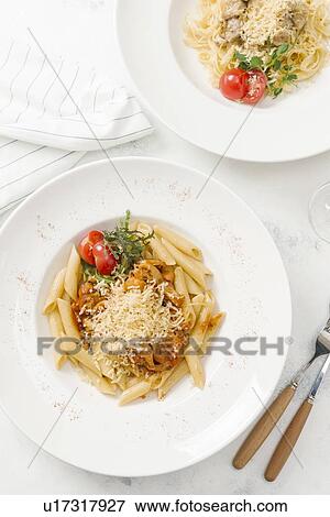 Bowl of pasta topped with cheese View Large Photo Image Stock Photo - Bowl of pasta topped with cheese. Fotosearch