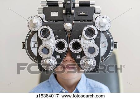 Boy having his eyes tested. View Large Photo Image Stock Photo - Boy having his eyes tested.. Fotosearch