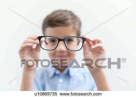 Boy holding glasses and looking through them. View Large Photo Image Stock Photography - Boy holding glasses and looking through them.. Fotosearch