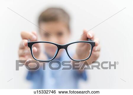 Stock Photograph - Boy holding glasses close up.. Fotosearch