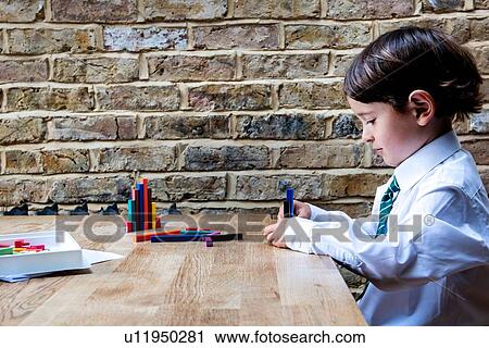 Boy in school uniform playing with colour sticks at home View Large Photo Image Stock Image - Boy in school uniform playing with colour sticks at home. Fotosearch