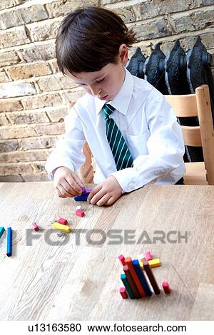 Boy in school uniform playing with colour sticks at home View Large Photo Image Stock Image - Boy in school uniform playing with colour sticks at home. Fotosearch