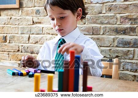 Boy in school uniform playing with colour sticks at home View Large Photo Image Stock Photography - Boy in school uniform playing with colour sticks at home. Fotosearch