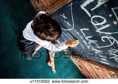 Boy in school uniform writing on blackboard at home View Large Photo Image Stock Image - Boy in school uniform writing on blackboard at home. Fotosearch