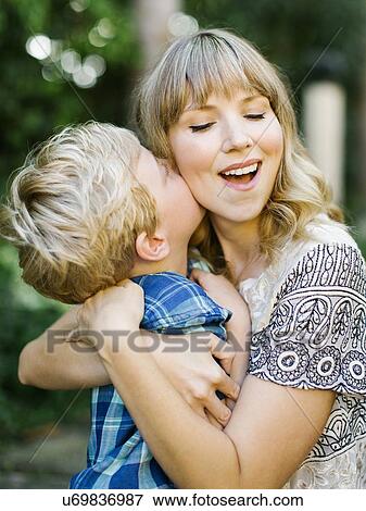 Stock Photo - Boy kissing his mother's cheek. Fotosearch