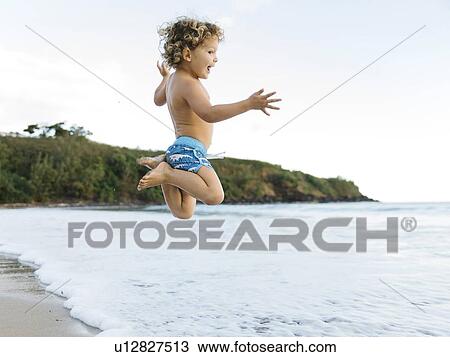 Boy playing on beach View Large Photo Image Stock Image - Boy playing on beach. Fotosearch