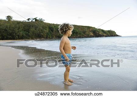 Boy playing on beach View Large Photo Image Stock Photography - Boy playing on beach. Fotosearch