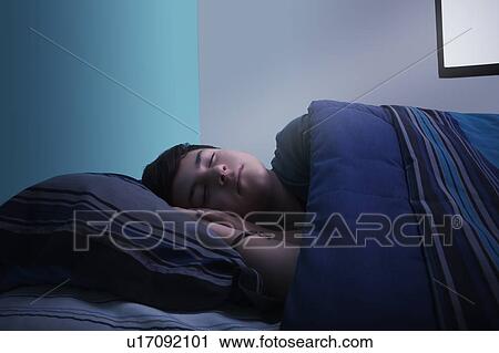Stock Image - Boy sleeping in bed. Fotosearch