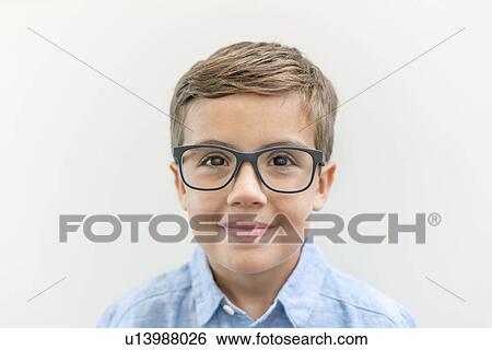 Stock Photograph - Boy wearing glasses, studio shot.. Fotosearch