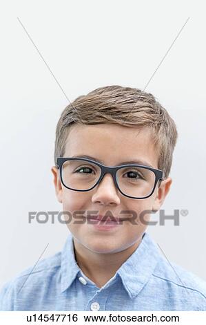 Stock Photograph - Boy wearing glasses, studio shot.. Fotosearch