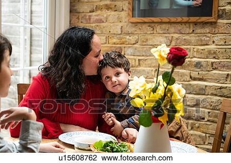 Boy with mother and toddler brother at table celebrating mothers day View Large Photo Image Stock Image - Boy with mother and toddler brother at table celebrating mothers day. Fotosearch