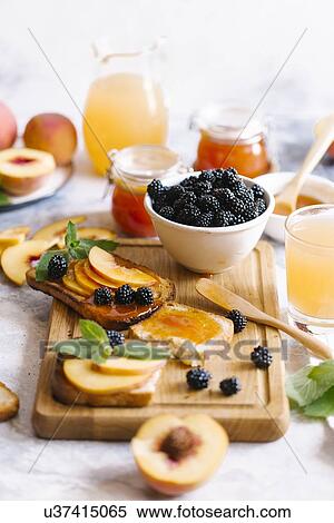 Breakfast spread with blackberries, peaches, toast and apricot jam View Large Photo Image Stock Photography - Breakfast spread with blackberries, peaches, toast and apricot jam. Fotosearch