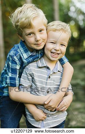 Stock Photo - Brothers hugging. Fotosearch