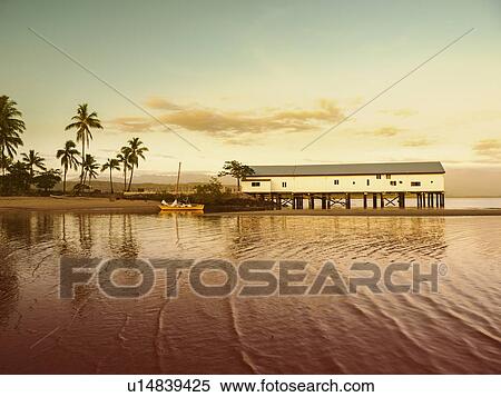 Building by beach at sunset in Port Douglas, Australia View Large Photo Image Stock Photography - Building by beach at sunset in Port Douglas, Australia. Fotosearch