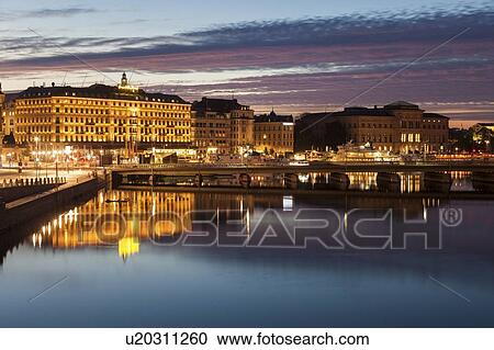 Stock Image - Buildings by river at sunset in Stockholm, Sweden. Fotosearch