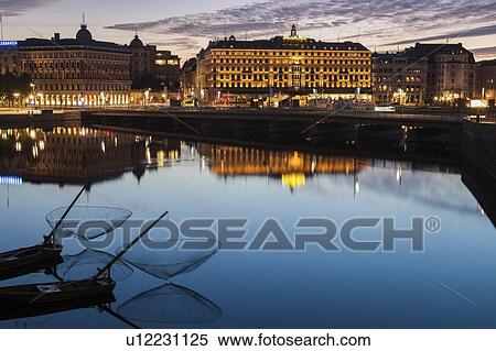 Stock Photography - Buildings by river at sunset in Stockholm, Sweden. Fotosearch