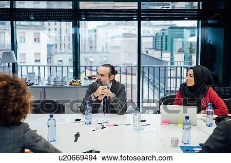 Business partners at brainstorming meeting in office View Large Photo Image Picture - Business partners at brainstorming meeting in office. Fotosearch