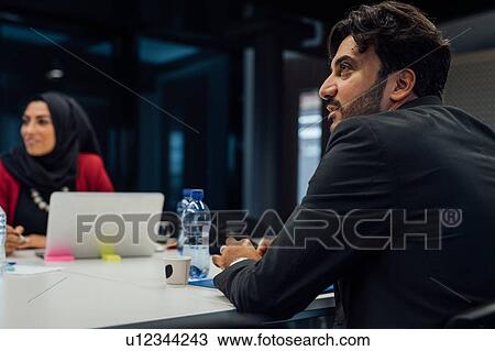 Business partners at brainstorming meeting in office View Large Photo Image Stock Image - Business partners at brainstorming meeting in office. Fotosearch