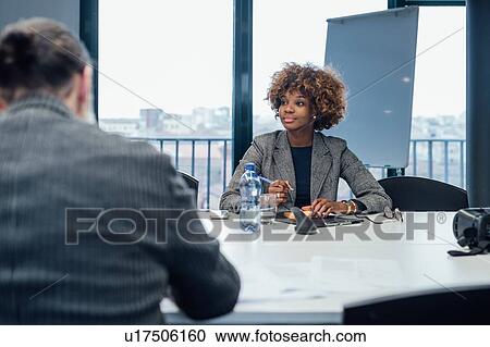 Business partners at brainstorming meeting in office View Large Photo Image Stock Image - Business partners at brainstorming meeting in office. Fotosearch