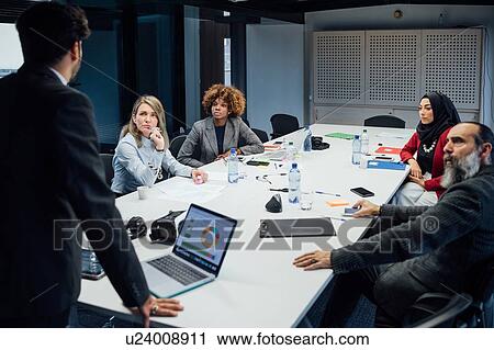 Business partners at brainstorming meeting in office View Large Photo Image Stock Image - Business partners at brainstorming meeting in office. Fotosearch